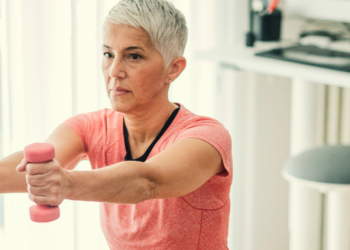 Mature woman using pink free weights